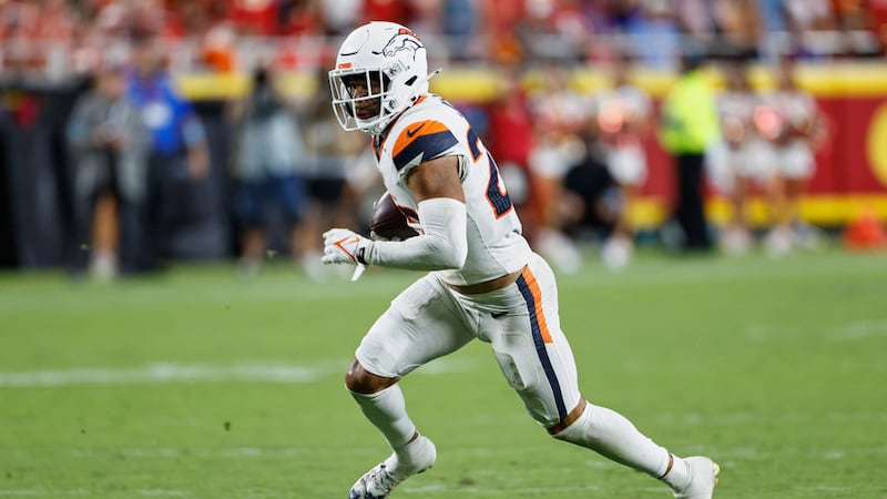 Denver Broncos safety Brandon Jones runs with the ball after intercepting a pass by Kansas...