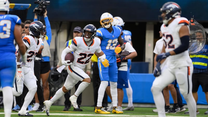 Denver Broncos safety Brandon Jones (22) reacts after intercepting a pass intended to Los...