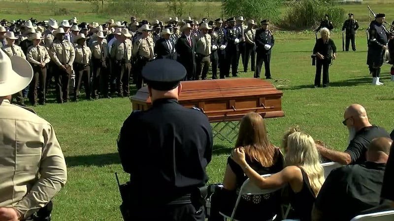 Scenes from the graveside service for Deputy Adam Sherifi